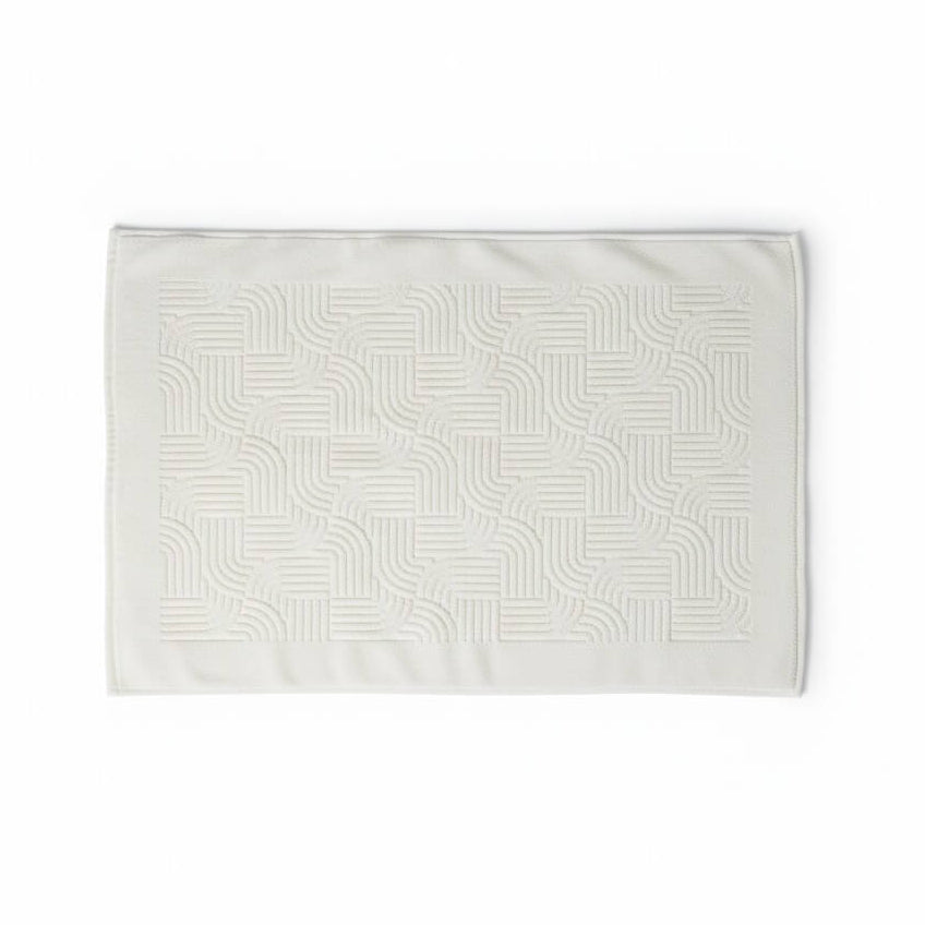 White bath mat with geometric pattern on a white background